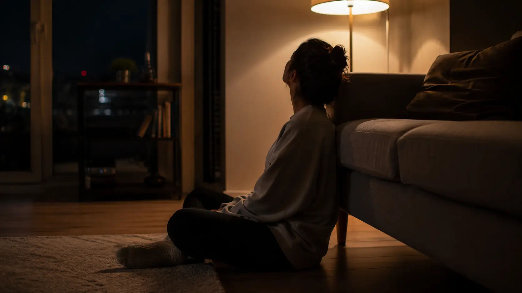 Birth chart attraction patterns moon sign — woman sitting alone on apartment floor at night staring at the ceiling
