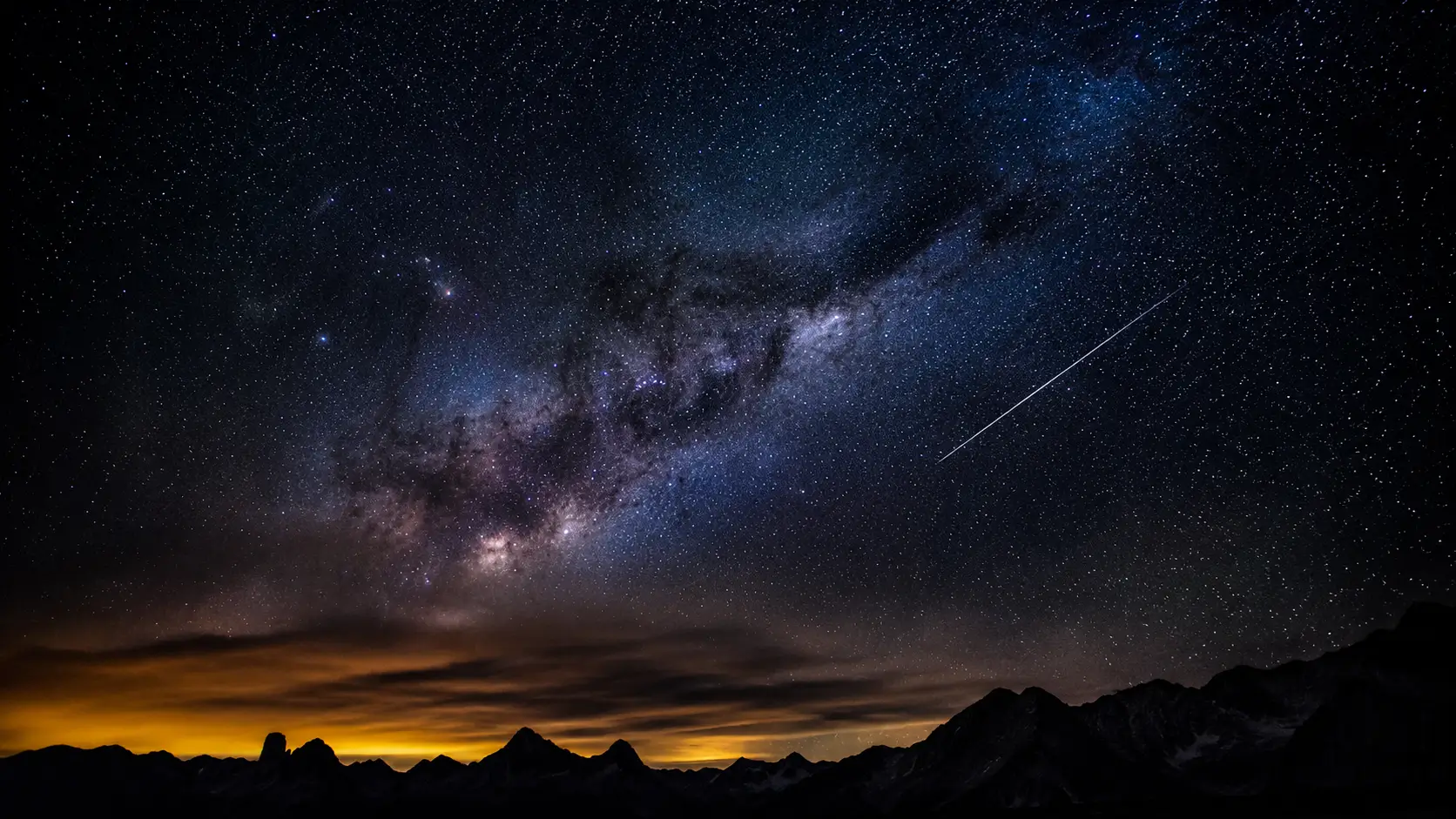 Divine love destiny astrology — wide night sky photograph showing the Milky Way and a single meteor trail, vast and ancient, as if holding a specific message written in the stars