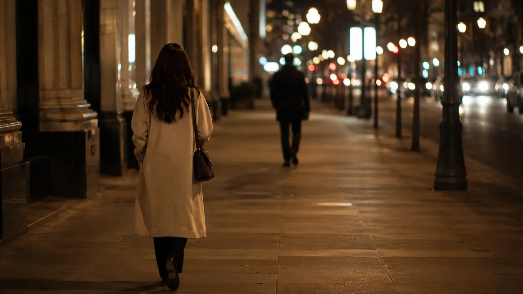 seventh house relationship astrology — woman walking alone at night with a blurred male silhouette in the distance, not yet meeting