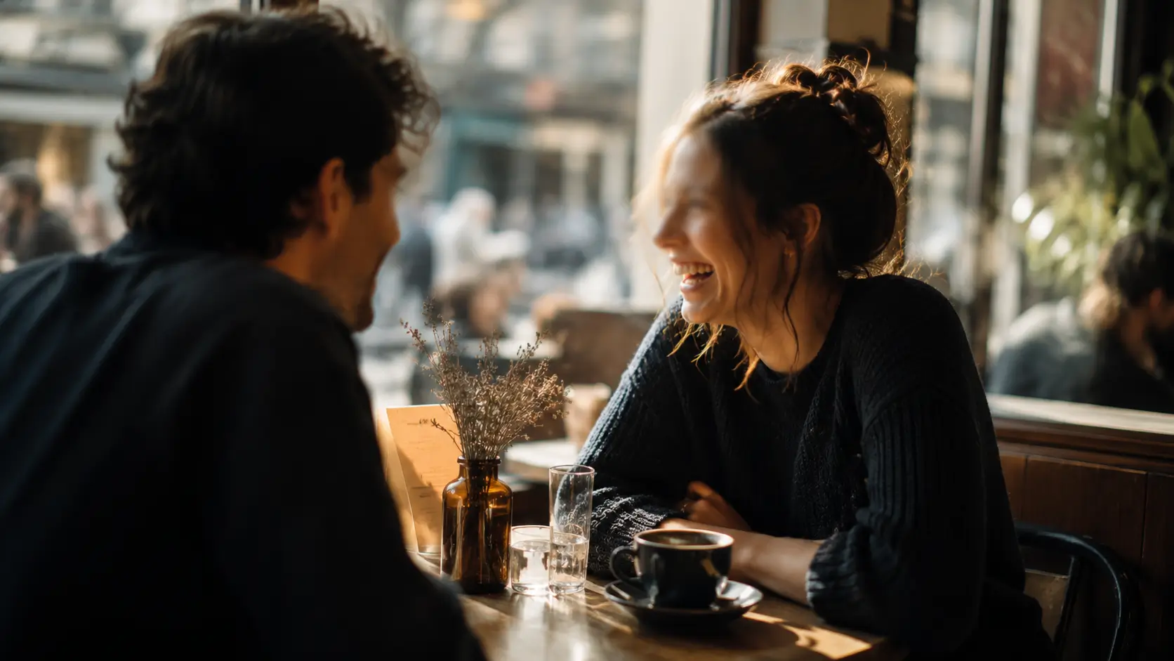 Venus sign compatibility soulmate — two people leaning toward each other at a café table, warm light, genuine connection