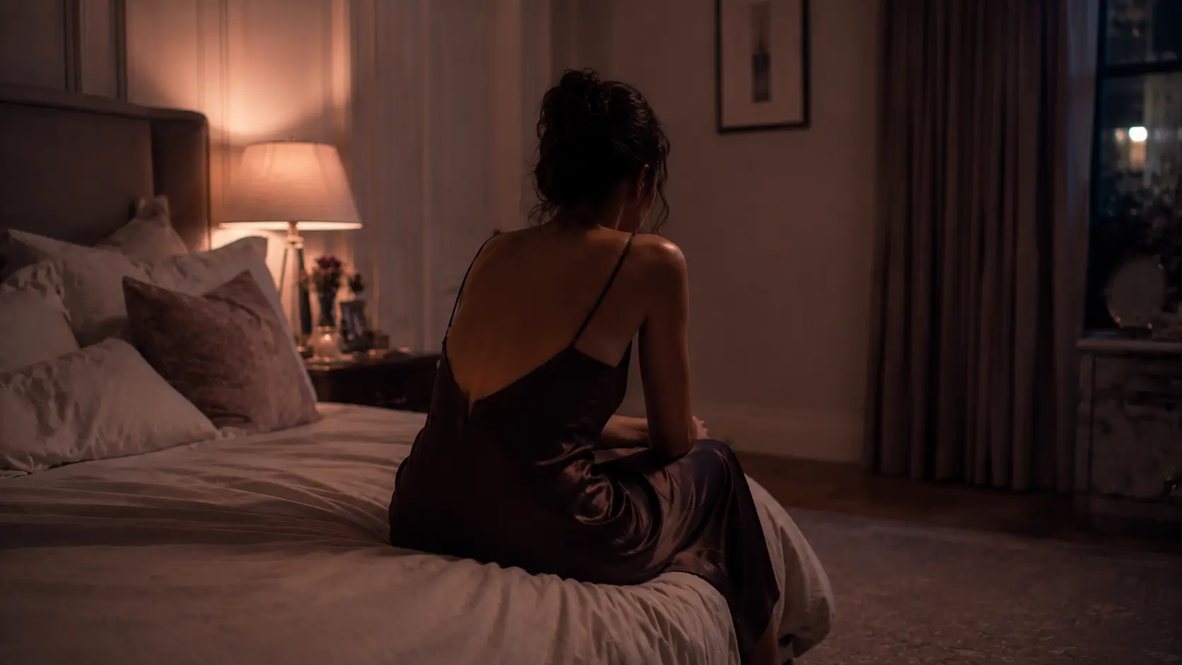 Zodiac signs bad communication — woman sitting at a kitchen table mid-sentence, gesturing as she speaks, the chair across from her empty, phone face-down beside her
