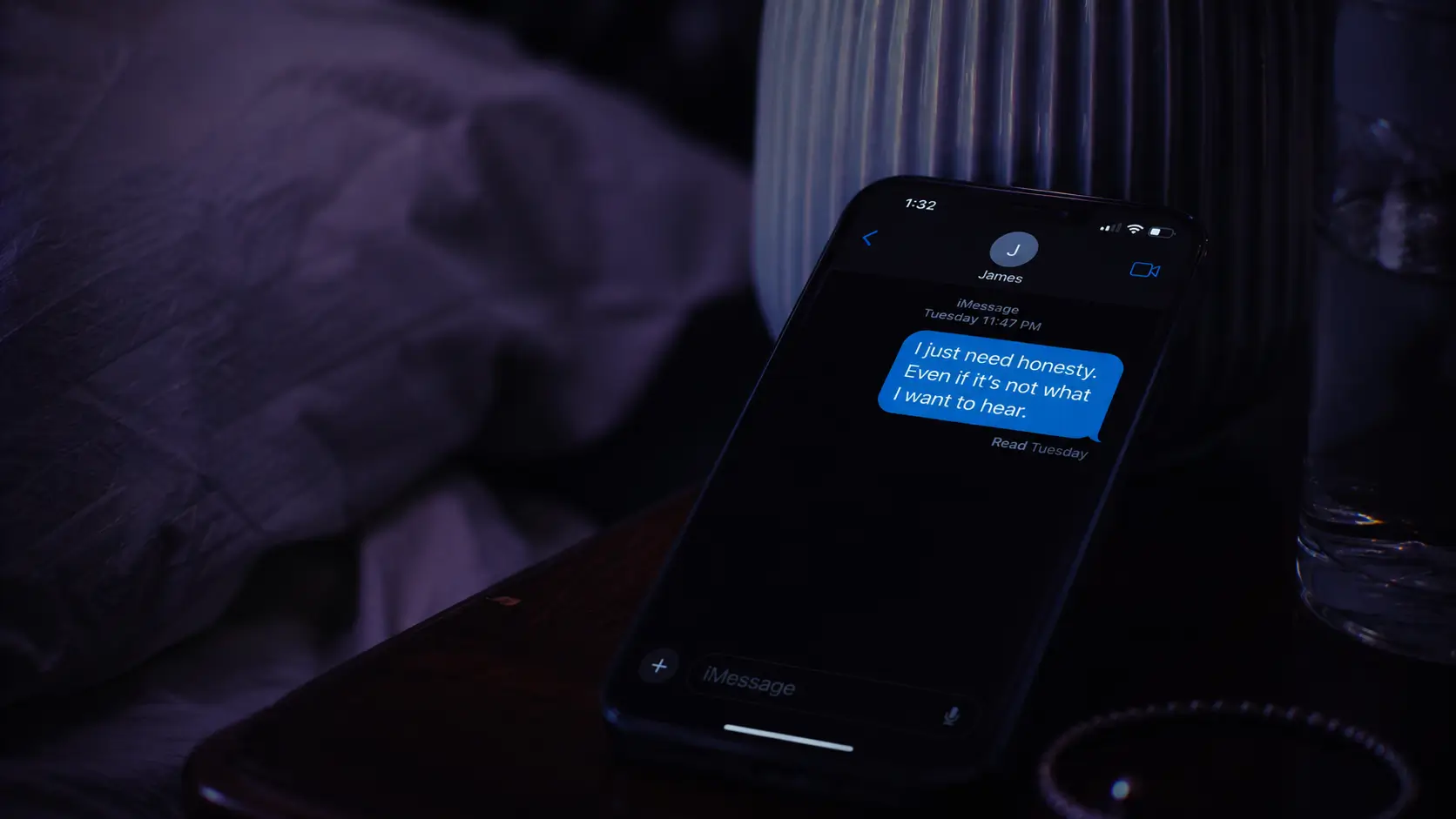 Zodiac signs that ghost — woman sitting alone at a café table looking at an unanswered message on her phone, coffee gone cold